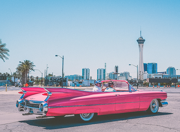 pink classic car in the city